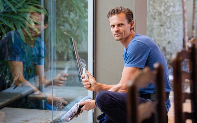A man cleaning the glass