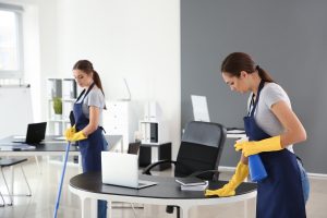 Team of janitors cleaning office